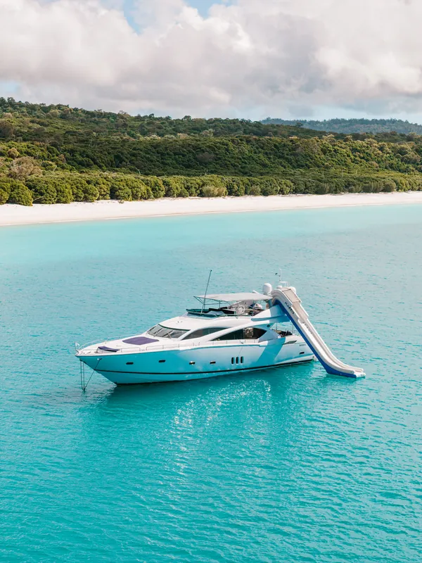 M/Y Alani, at anchor off a white sand beach