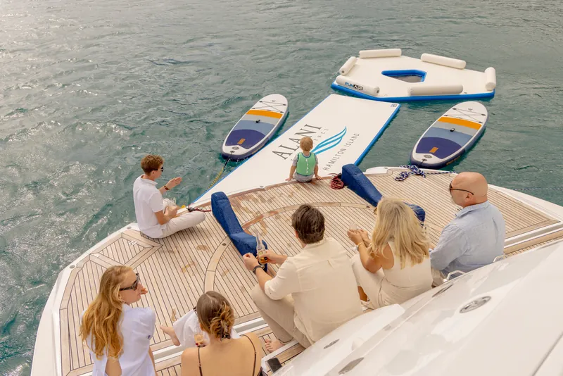 M/Y Alani, guests on the bow with paddleboards and the splash mat