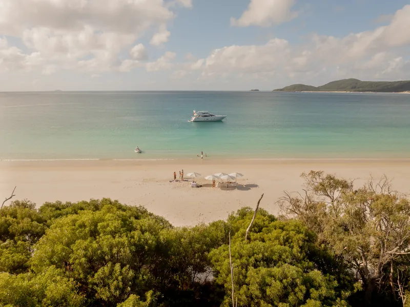 M/Y Alani, looking down over the beach from the headland