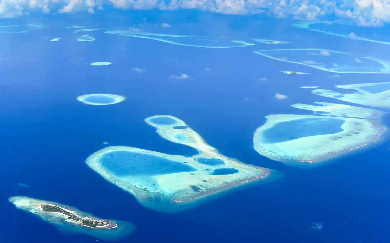 Maldives atolls ringed by deep blue ocean