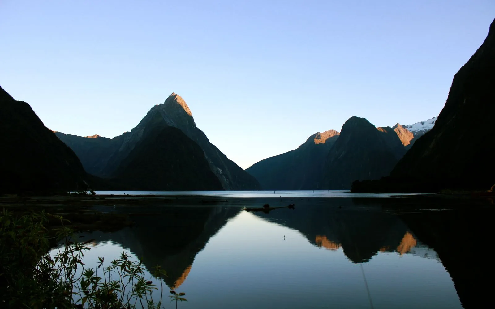 Mountains reflected in calm Milford Sound water
