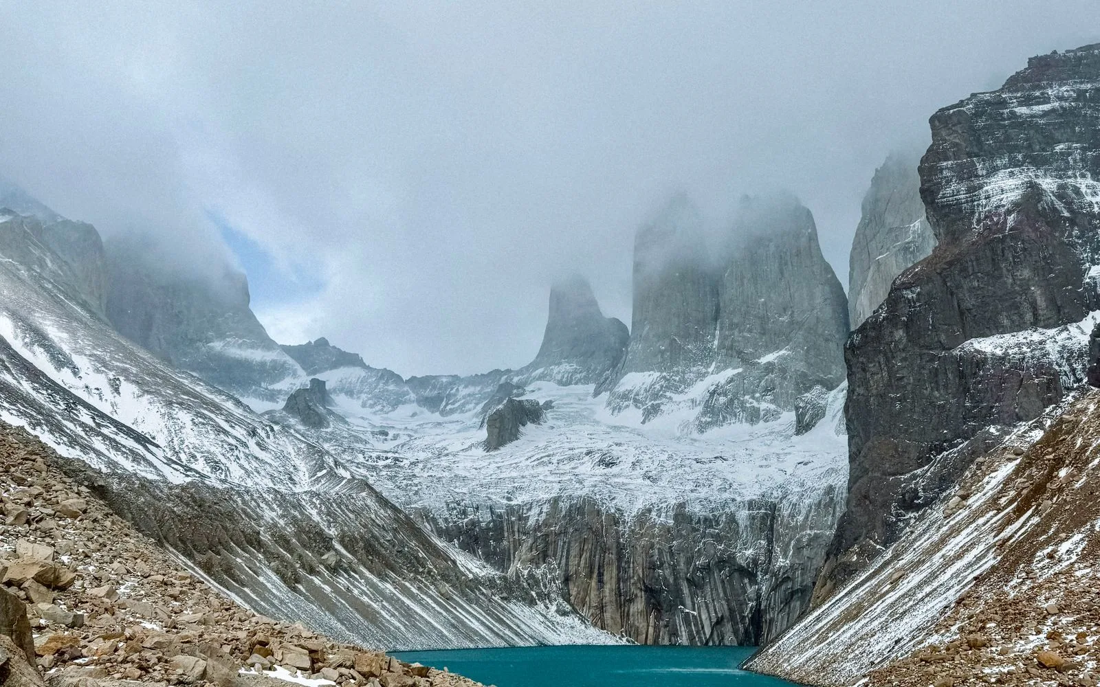 Glacial lake beneath snowy peaks in Torres del Paine, Chile