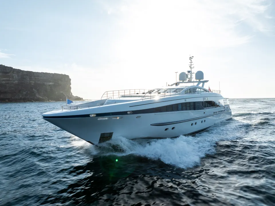 M/Y Lumir bow on with the headland behind