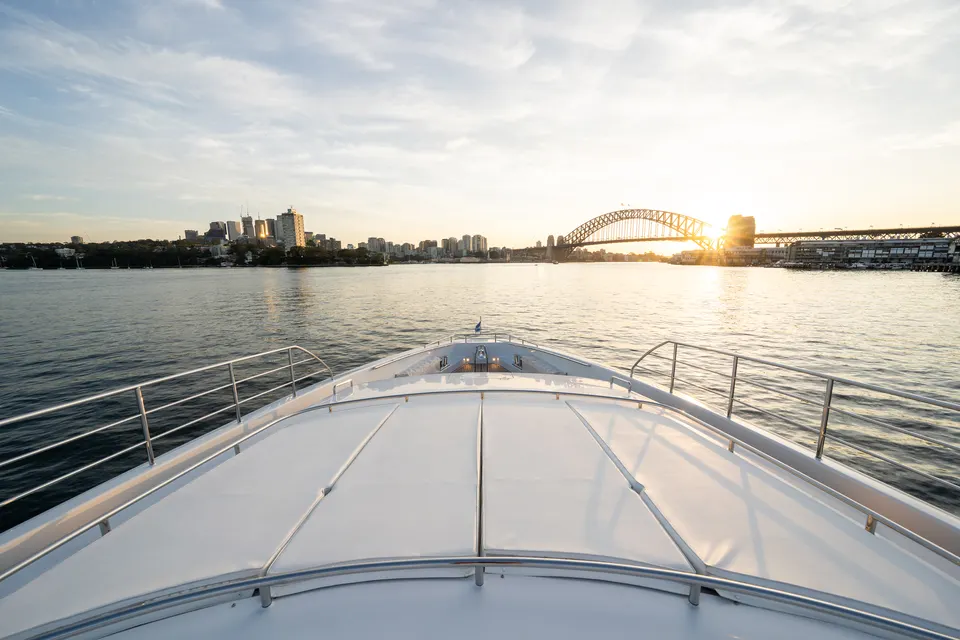 M/Y Lumir's bow at sunset with the Harbour Bridge ahead
