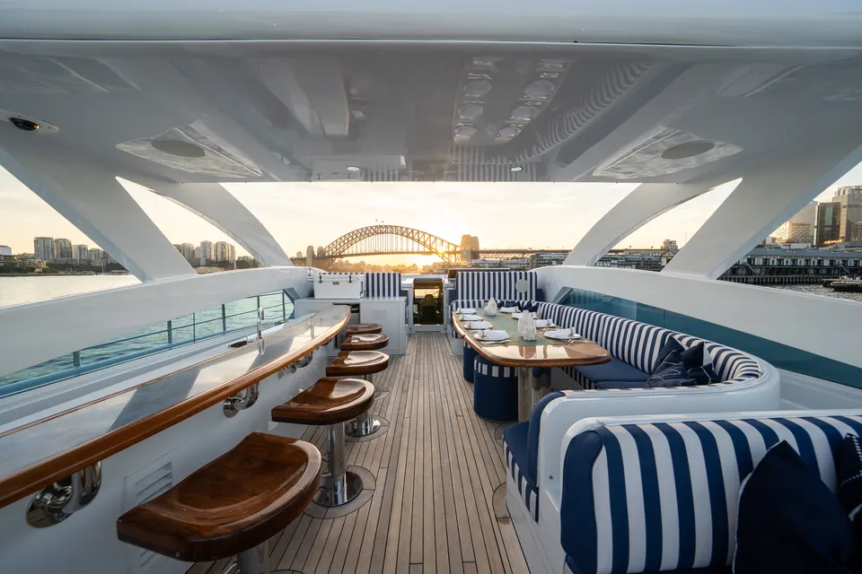 M/Y Lumir, The sun deck at sunset with the Harbour Bridge beyond