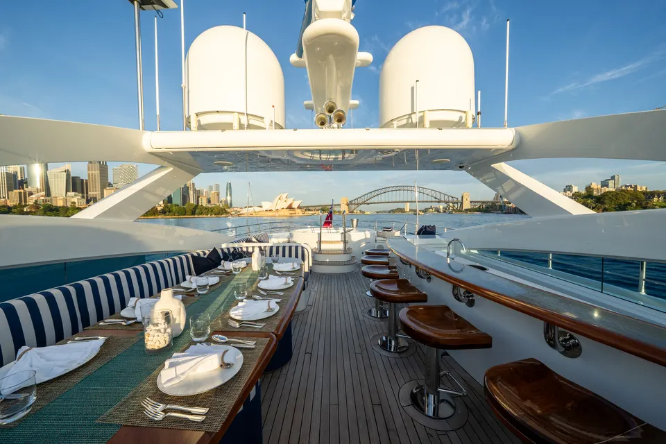 M/Y Lumir, Sun deck dining under the hardtop at dusk
