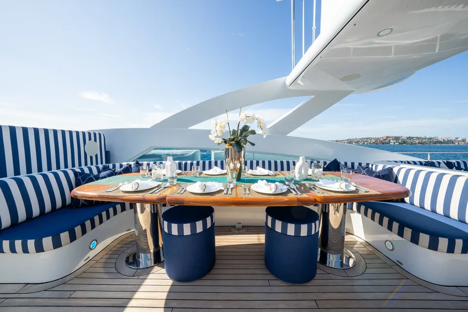 M/Y Lumir, Sun deck table set with flowers and glassware