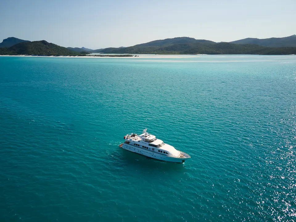 M/Y Sea Raes, from the air over turquoise shallows