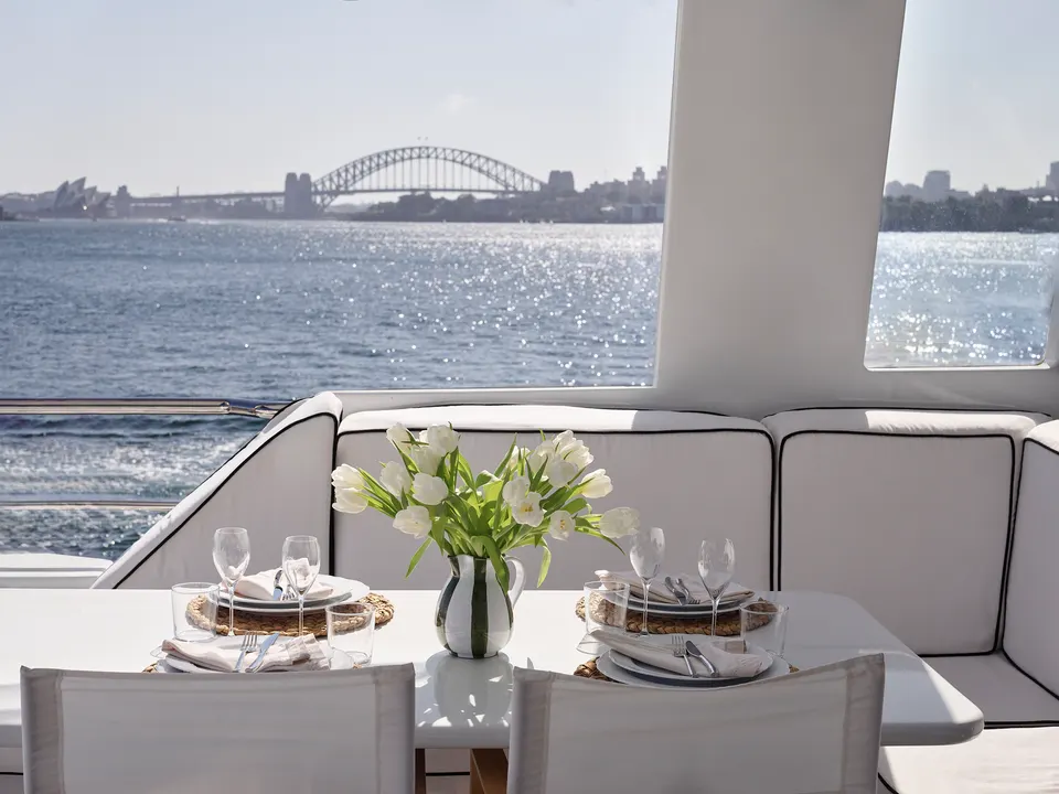 M/Y Sea Raes, the table set on the upper deck, the Harbour Bridge behind